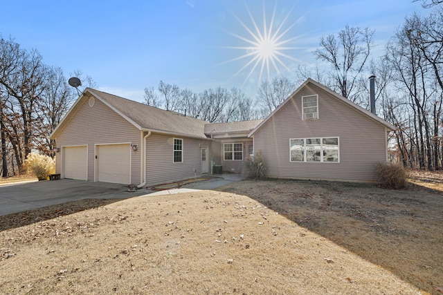 view of front of house with a garage and central AC unit