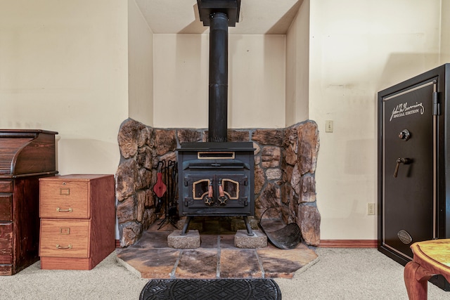 interior details featuring a wood stove and carpet floors