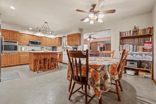 dining area with ceiling fan and sink