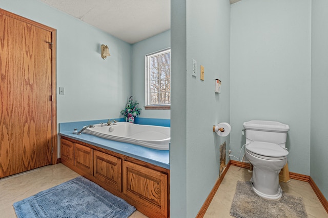 bathroom with a bathtub, toilet, and a textured ceiling