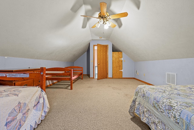 carpeted bedroom featuring ceiling fan, a textured ceiling, and vaulted ceiling