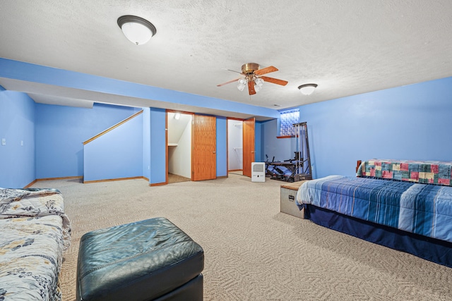 bedroom featuring a textured ceiling, carpet floors, and ceiling fan