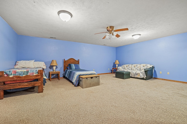 bedroom featuring carpet, a textured ceiling, and ceiling fan