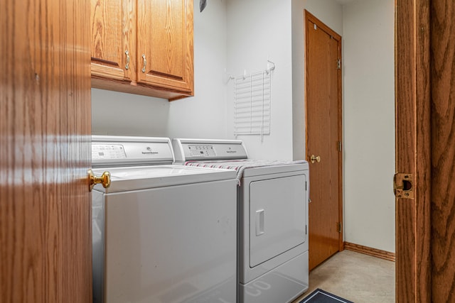 laundry area featuring cabinets and independent washer and dryer