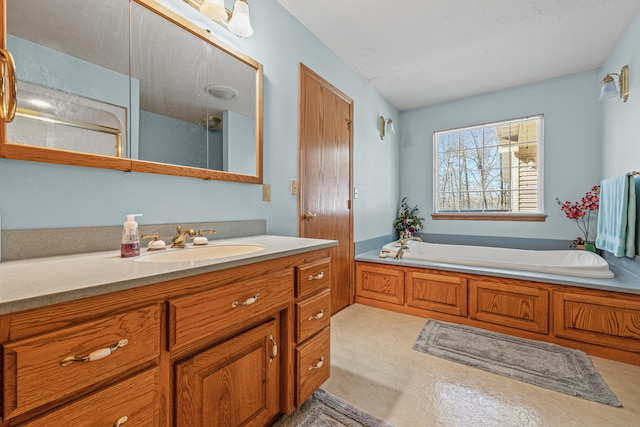 bathroom with vanity and a tub