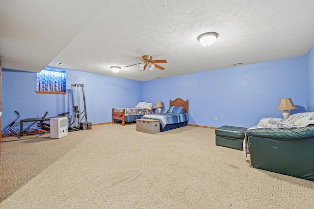 bedroom featuring carpet flooring, ceiling fan, and a textured ceiling