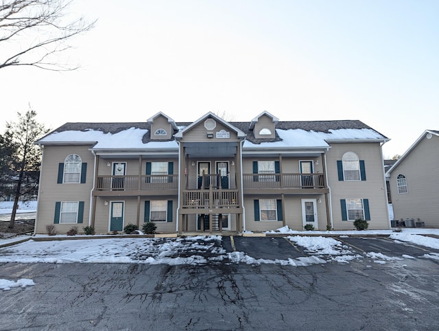 multi unit property featuring a balcony and central air condition unit