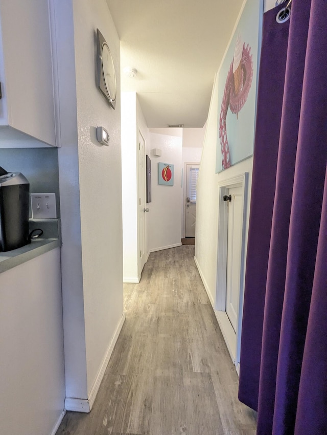 corridor featuring light hardwood / wood-style flooring