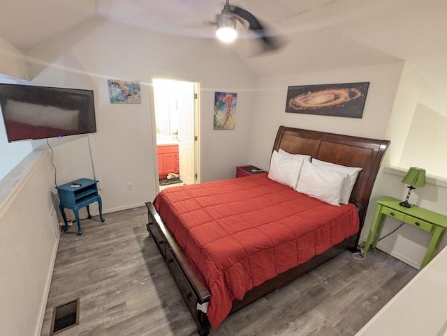 bedroom featuring ceiling fan, vaulted ceiling, wood-type flooring, and ensuite bath