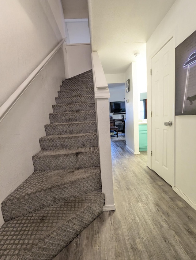 staircase featuring hardwood / wood-style flooring