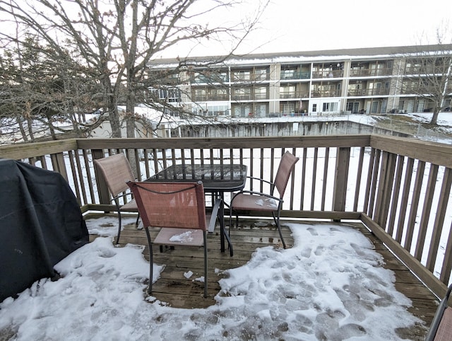 snow covered deck featuring a grill