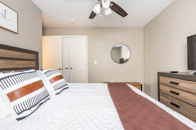 bedroom featuring ceiling fan and a closet