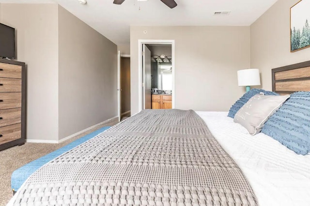 bedroom featuring carpet flooring, ceiling fan, and ensuite bath