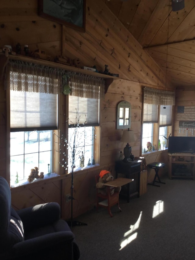 living room featuring carpet, vaulted ceiling, and wooden walls