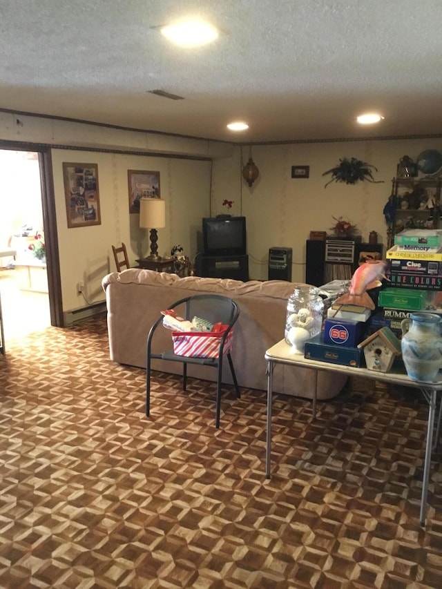 living area with visible vents and a textured ceiling