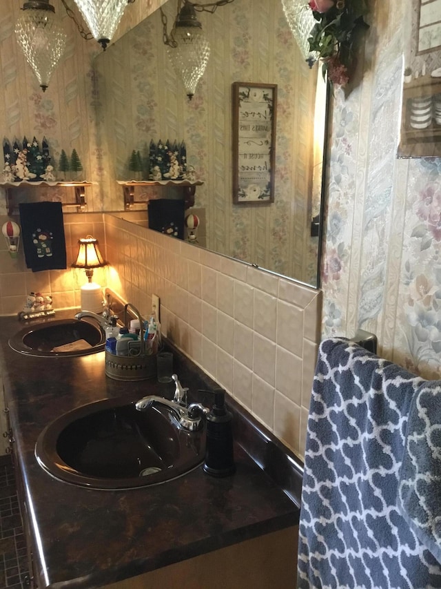 bathroom with sink and tasteful backsplash