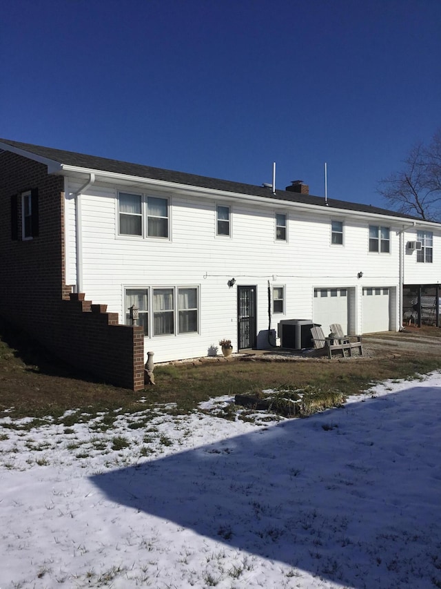 view of front of home featuring central AC and a garage