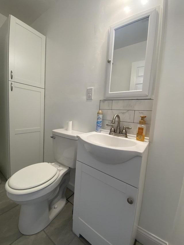 bathroom with backsplash, tile patterned flooring, vanity, and toilet