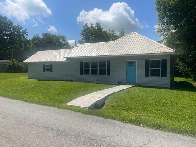 214 E Wilson St, Wheaton, MO 64874 - ranch-style home featuring a front yard and a metal roof