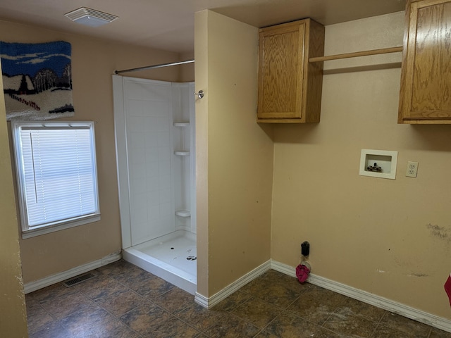 washroom with cabinets and hookup for a washing machine