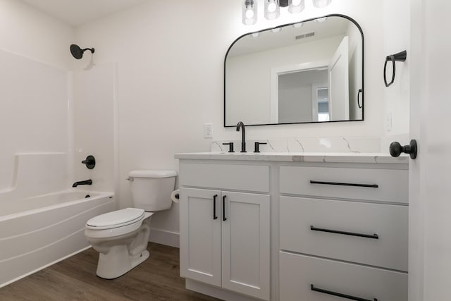 full bathroom featuring hardwood / wood-style flooring, vanity, toilet, and bathing tub / shower combination