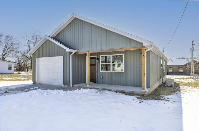 view of front of house with central AC unit and a garage