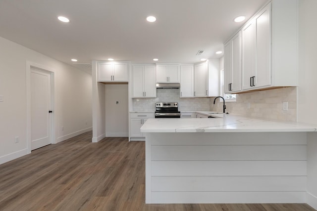 kitchen with white cabinets, wood finished floors, stainless steel range with electric stovetop, and under cabinet range hood