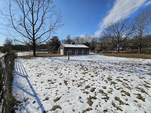 snowy yard with an outbuilding