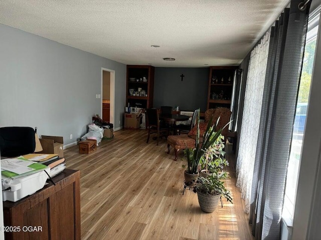 interior space with a textured ceiling and hardwood / wood-style flooring