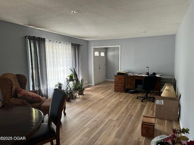 office space featuring a textured ceiling and light hardwood / wood-style flooring