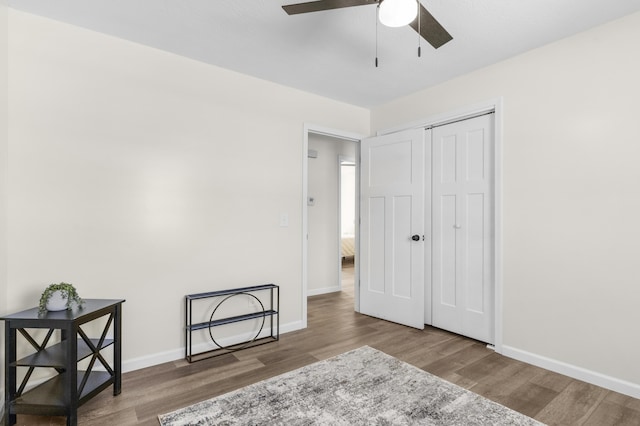 bedroom featuring ceiling fan, wood-type flooring, and a closet