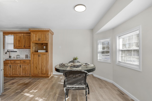 kitchen with backsplash and light wood-type flooring