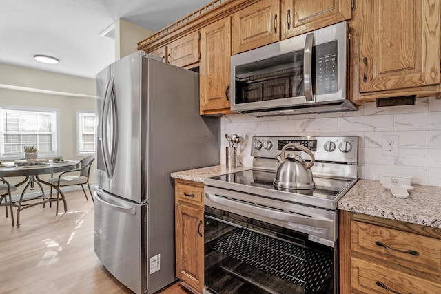 kitchen featuring stainless steel appliances and tasteful backsplash