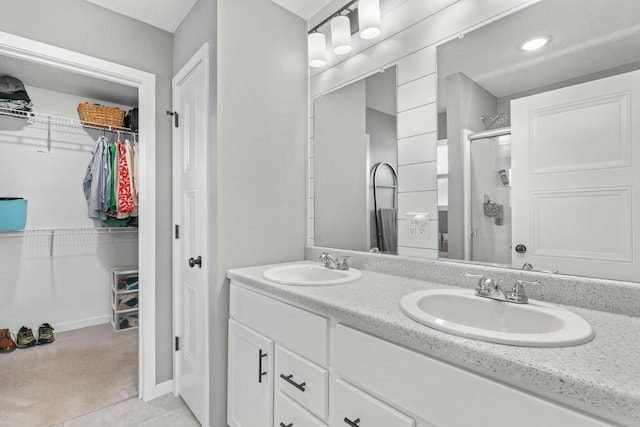 bathroom featuring vanity and a shower with shower door