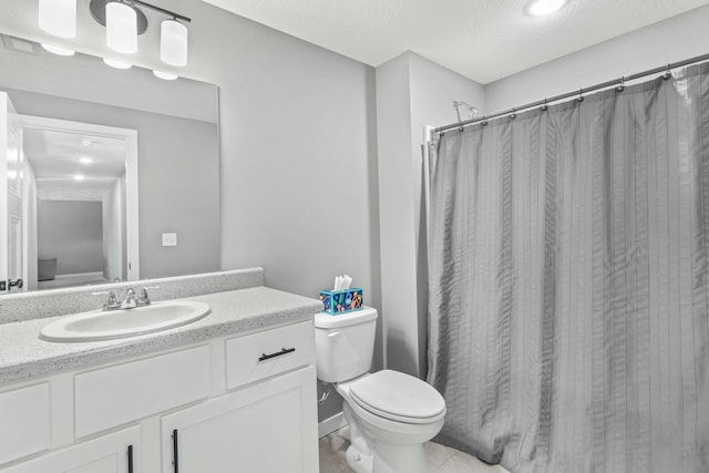 bathroom with vanity, toilet, and curtained shower