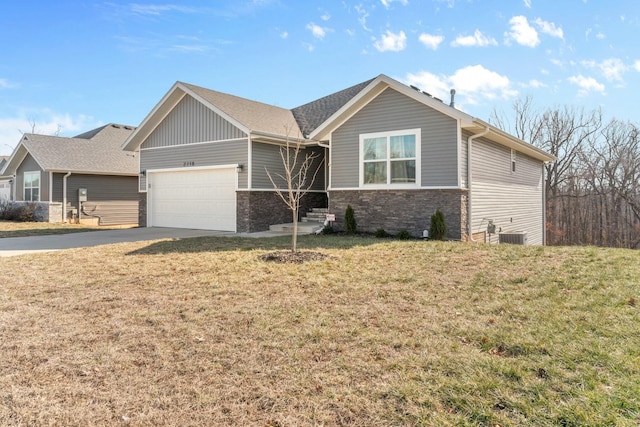 view of front of property featuring a garage and a front lawn