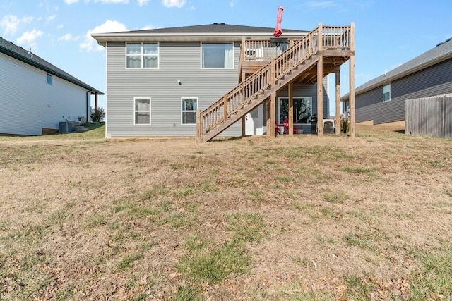 rear view of property with cooling unit and a lawn