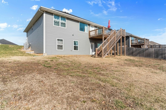 back of house with a wooden deck, ac unit, and a yard