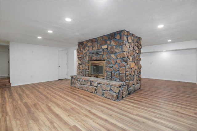 unfurnished living room with a fireplace and light hardwood / wood-style floors