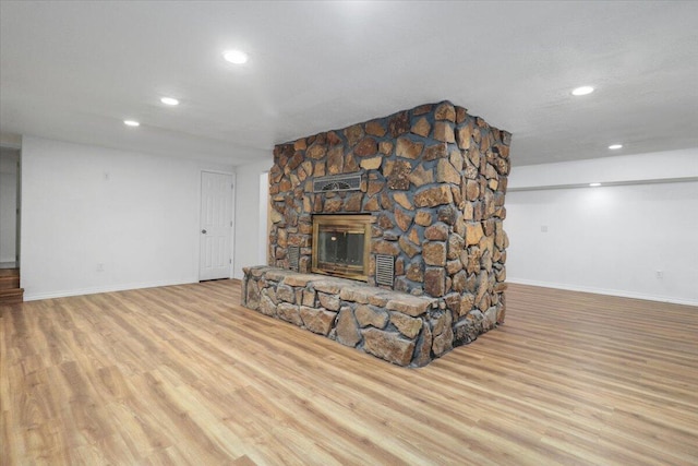 living room featuring a fireplace and light hardwood / wood-style flooring