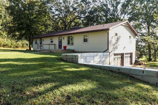 view of front of house featuring a garage and a front lawn