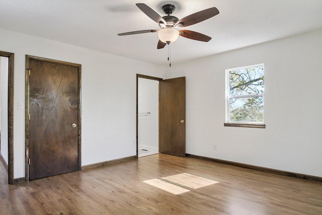 unfurnished bedroom with light hardwood / wood-style floors and ceiling fan