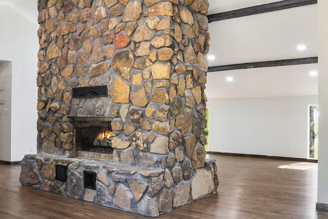 living room featuring beamed ceiling, dark hardwood / wood-style floors, and a fireplace