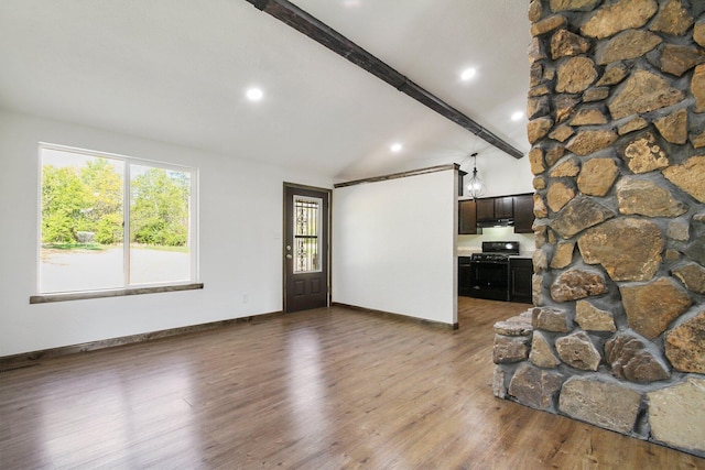 unfurnished living room with vaulted ceiling with beams and wood-type flooring