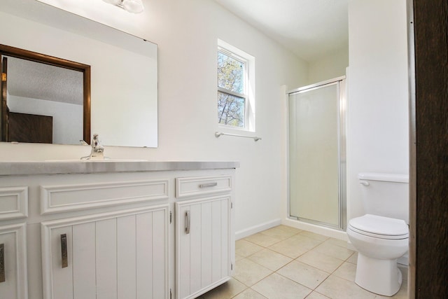 bathroom featuring toilet, vanity, tile patterned floors, and a shower with door