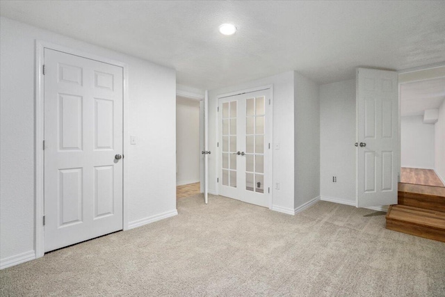 unfurnished bedroom featuring light colored carpet and a textured ceiling