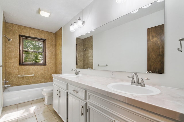 full bathroom with tile patterned flooring, vanity, tiled shower / bath combo, and toilet