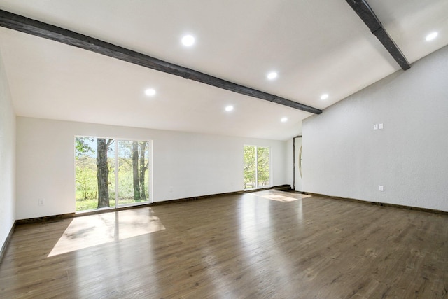 empty room featuring dark hardwood / wood-style floors and lofted ceiling with beams