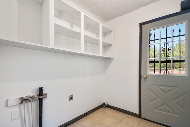 laundry area featuring a textured ceiling and hookup for an electric dryer