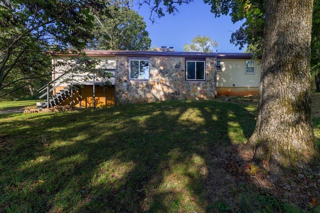 rear view of house with a yard